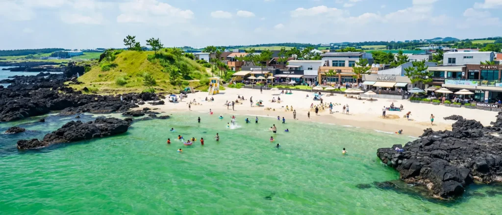Korea's island escape — clear shallow water at Hamdeok, sunsets at Hyeopjae, and the resort coast at Jungmun.