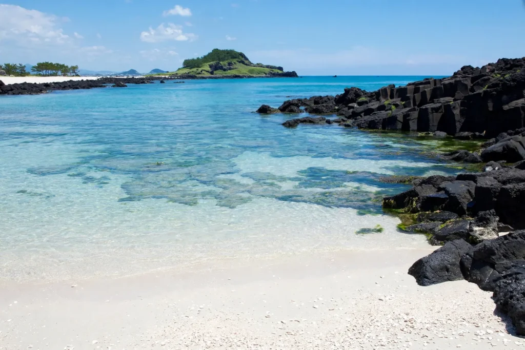 Clear turquoise water and white sand at Hyeopjae Beach, Jeju Island